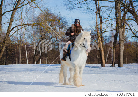 Man in suit of ancient warrior riding big white horse Man in suit of ancient warrior riding big white horse 50357701