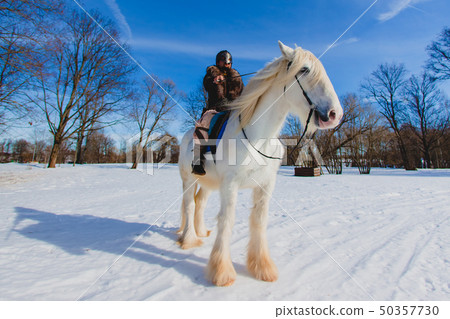 Man in suit of ancient warrior riding big white horse Man in suit of ancient warrior riding big white horse 50357730