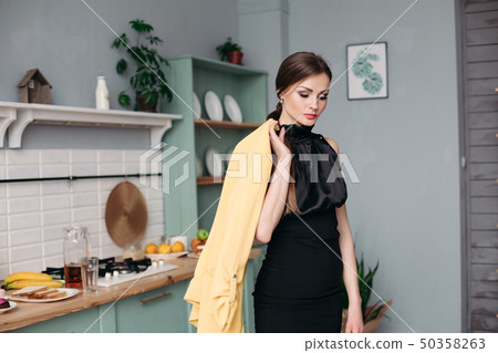 Young gorgeous lady in elegant black dress posing Young gorgeous lady in elegant black dress posing 50358263