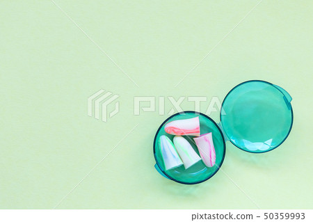 Earplugs in a box on the green background. Earplugs in a box on the green background. 50359993
