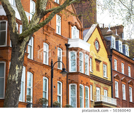 Luxury brick house with white windows in quiet area in central London. Apartments on the banks of Luxury brick house with white windows in quiet area in central London. Apartments on the banks of 50360040