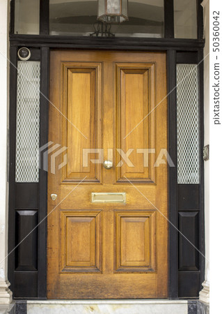 Wooden Entrance Door to residential building in London. Typical door in the English style. Wooden Entrance Door to residential building in London. Typical door in the English style. 50360042