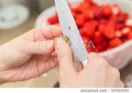 The hand of a woman who cuts strawberries 50362093