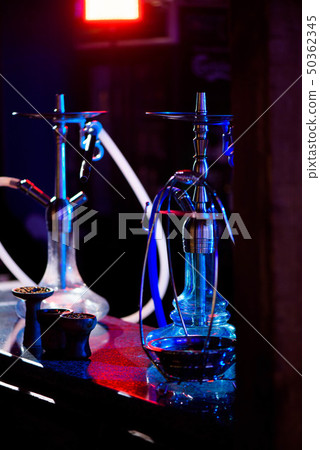 Group of eastern hookahs on table of a bar. Group of eastern hookahs on table of a bar. 50362345