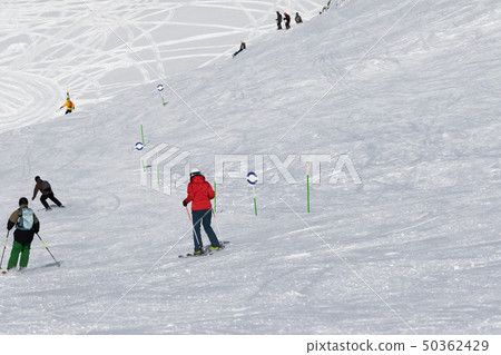 Skiers and snowboarders downhill Skiers and snowboarders downhill 50362429