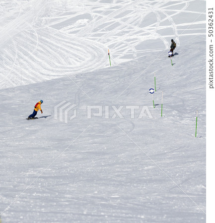 Two snowboarders downhill 50362431