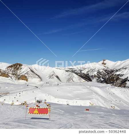 Snowy ski slope at sun winter day 50362448