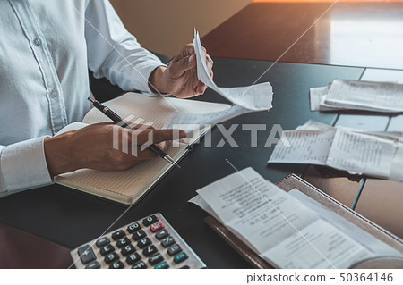 Woman with bills and calculator. Woman using 50364146