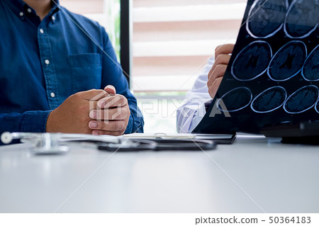 Patient listening intently to a male doctor Patient listening intently to a male doctor 50364183