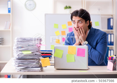 Young male handsome employee in conflicting priorities concept Young male handsome employee in conflicting priorities concept 50367566