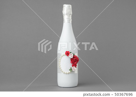Champagne bottle decorated with roses. Champagne bottle decorated with roses. 50367696