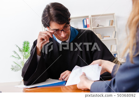 Young woman visiting male lawyer  50368092