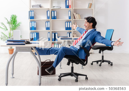 Young happy male employee in the office Young happy male employee in the office 50368563