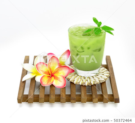 ice green tea milk in a glass and plumeria on ice green tea milk in a glass and plumeria on 50372464