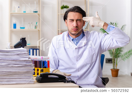 Young male chemist working in the lab  50372592
