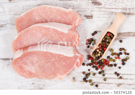 Raw meat pork steaks with pepper 50374120