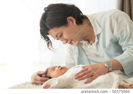 A father who puts a baby to sleep 50375660