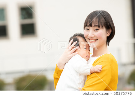 A young mother holding a baby Japanese parent and child A young mother holding a baby Japanese parent and child 50375776