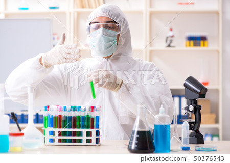 Young handsome chemist working in the lab Young handsome chemist working in the lab 50376543