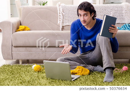 Young good looking man knitting at home 50376634