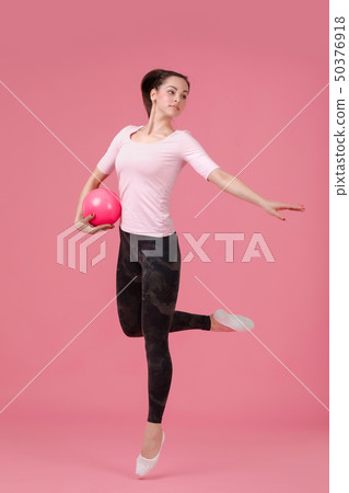 smiling woman jumping with the ball 50376918