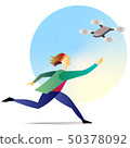 Young man running with drone in sky 50378092