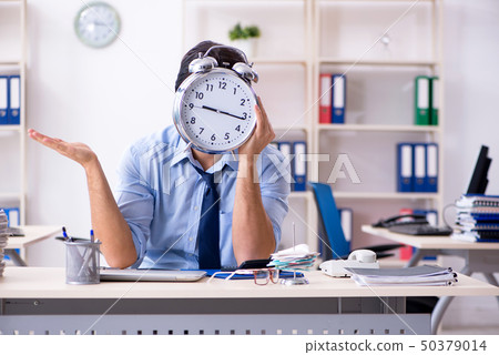 Young male businessman employee unhappy with excessive work   50379014