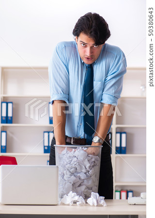Businessman rejecting new ideas with lots of papers Businessman rejecting new ideas with lots of papers 50380643