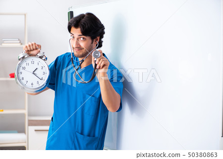 Young male doctor in front of whiteboard Young male doctor in front of whiteboard 50380863