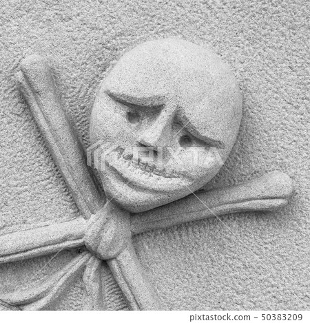 Crossbones carved in a tombstone 50383209