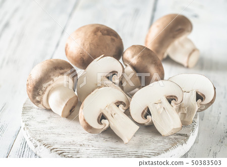 Champignon mushrooms on the wooden board Champignon mushrooms on the wooden board 50383503