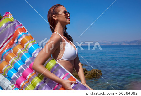 A beautiful young girl lies on a mattress in the A beautiful young girl lies on a mattress in the 50384382