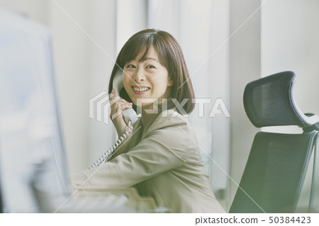 Women calling in the office Women calling in the office 50384423