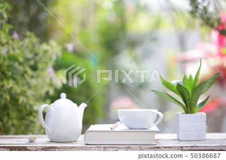 White coffee cup and notebooks on wooden White coffee cup and notebooks on wooden 50386687