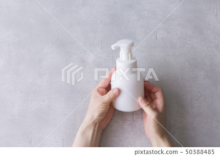 Hand holding a white bottle Hand holding a white bottle 50388485