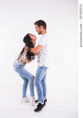 Young couple dancing social latin dance bachata, merengue, salsa. Two elegance pose on white 50389332