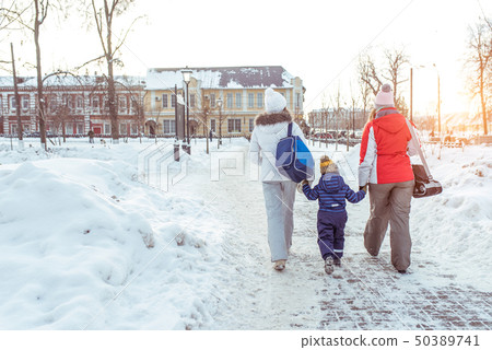 A young family mother little son, with woman girlfriend goes hands. Back view. Come back from 50389741
