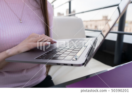 Female hands are typing on a laptop. Female hands are typing on a laptop. 50390201