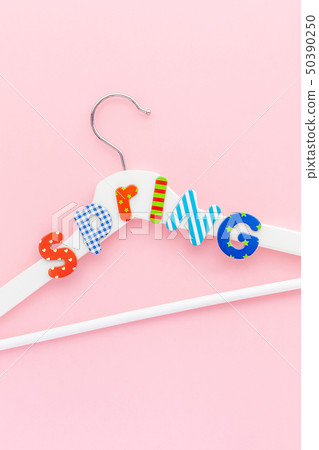White hangers with sale text on pink background White hangers with sale text on pink background 50390250