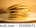 Tasty pancakes on white plate, wood background 50390671