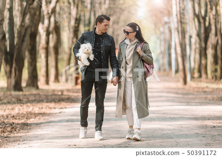 Young couple in the park outdoors at an authentic table in a cafe 50391172