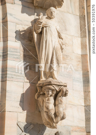Marble statue on roof of Duomo in Milan 50391976