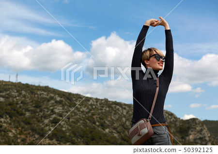 The fashion young woman posing in mountains The fashion young woman posing in mountains 50392125