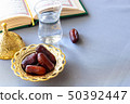 Still life Organic dates, cup of pure drinking water and quran book. Iftar Ramadan concept 50392447