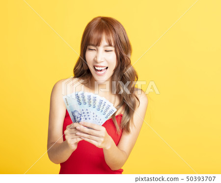 Portrait of cheerful young woman showing the Portrait of cheerful young woman showing the 50393707