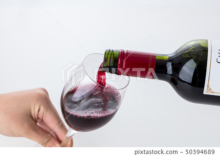 hand pouring glass of wine