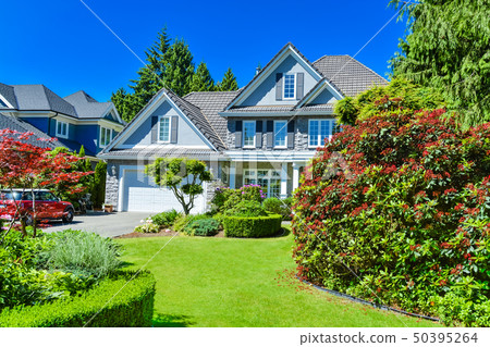 Luxury suburban house with double garage and car 50395264