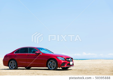 Coast drive image (Red car and sandy beach with blue sky) Coast drive image (Red car and sandy beach with blue sky) 50395888