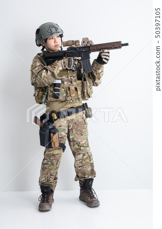 A cool girl wearing a camouflage outfit on a white background is a survival game with a gun 50397105
