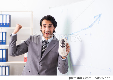 Young handsome businessman in front of whiteboard Young handsome businessman in front of whiteboard 50397336